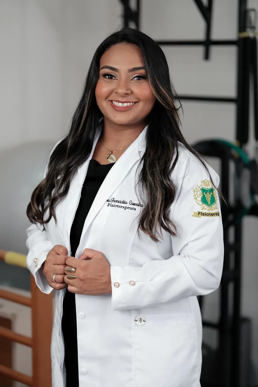 Dra. Francicléia Carvalho, fisioterapeuta, sorrindo de jaleco
